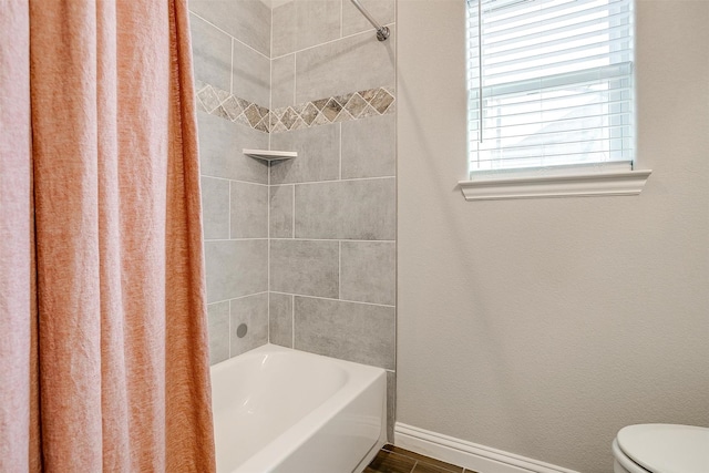 bathroom featuring toilet and shower / bath combo