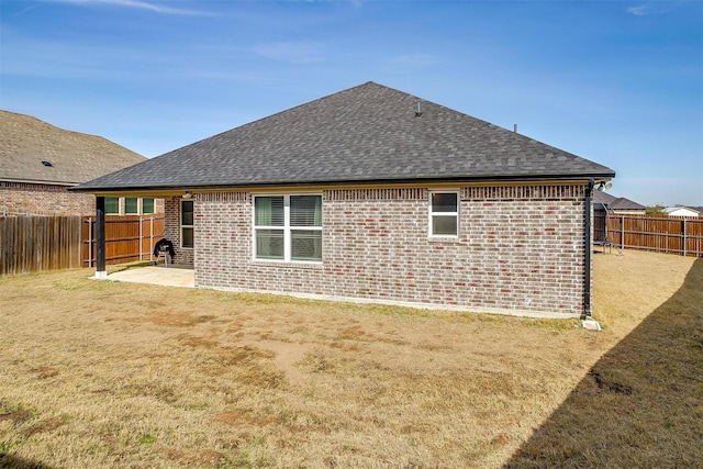 back of house featuring a patio and a yard