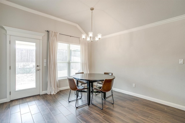 dining space featuring an inviting chandelier, ornamental molding, and dark hardwood / wood-style floors