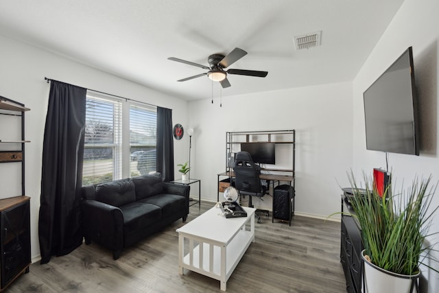 living room with ceiling fan and hardwood / wood-style floors