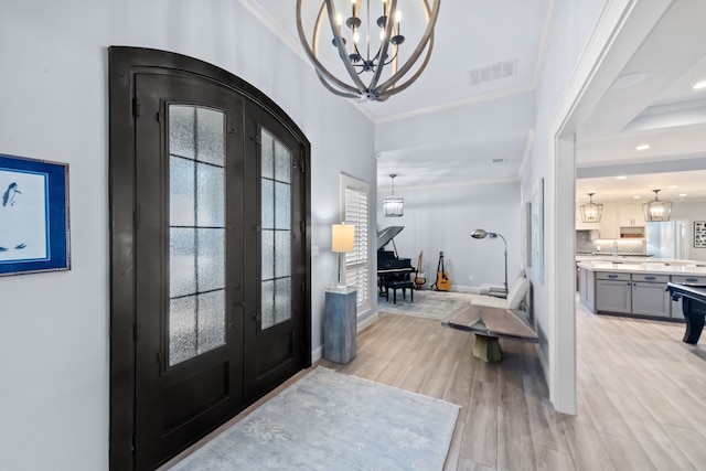4800 Lusk Ln, Flower Mound, TX 75028 - entryway with french doors, a chandelier, crown molding, light wood-style flooring, and baseboards