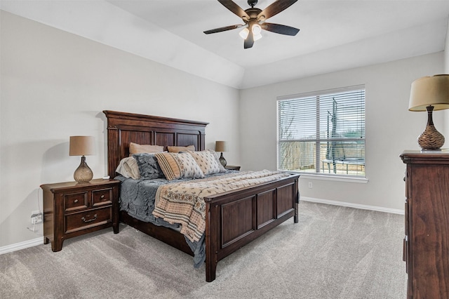 bedroom featuring light carpet, vaulted ceiling, and ceiling fan