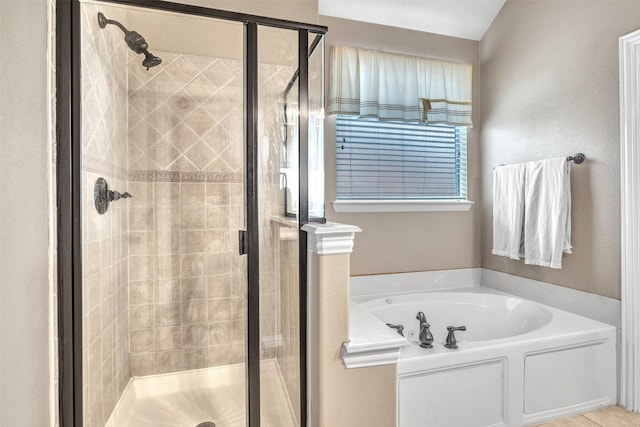 bathroom featuring shower with separate bathtub