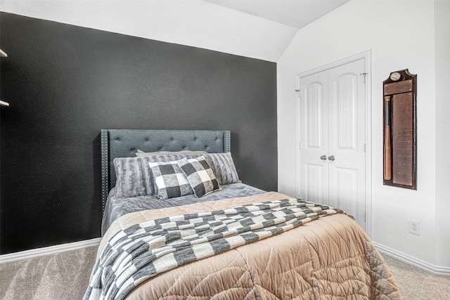 bedroom featuring vaulted ceiling, a closet, and carpet