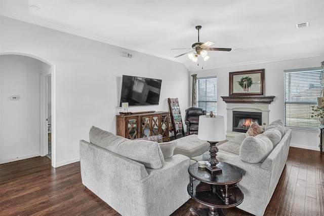 living room with dark wood-type flooring, ceiling fan, crown molding, and a wealth of natural light