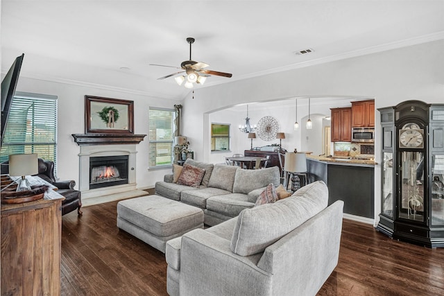 living room featuring crown molding, ceiling fan with notable chandelier, and dark hardwood / wood-style floors