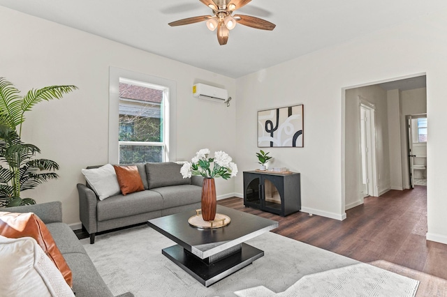 living room featuring dark wood-style floors, an AC wall unit, a ceiling fan, and baseboards