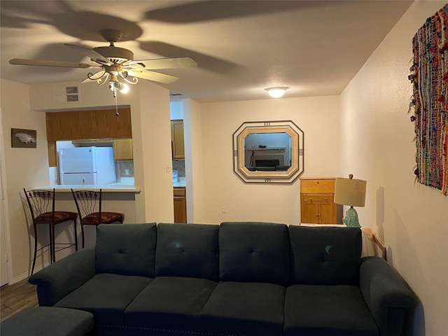 living room featuring hardwood / wood-style floors and ceiling fan