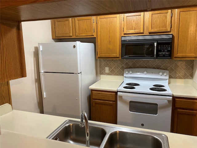 kitchen with sink, white appliances, and backsplash