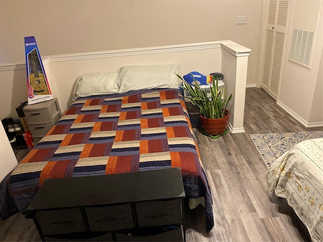 bedroom with dark wood-type flooring