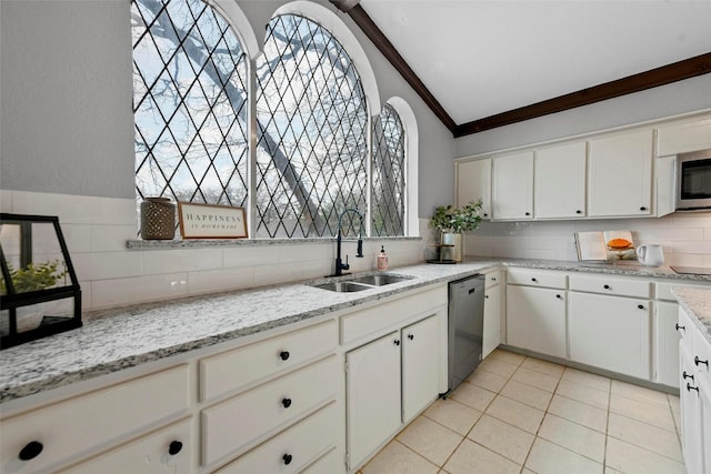 kitchen featuring crown molding, light tile patterned floors, appliances with stainless steel finishes, vaulted ceiling, and a sink