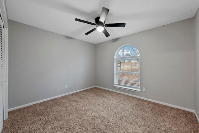 unfurnished room with carpet flooring, ceiling fan, and baseboards