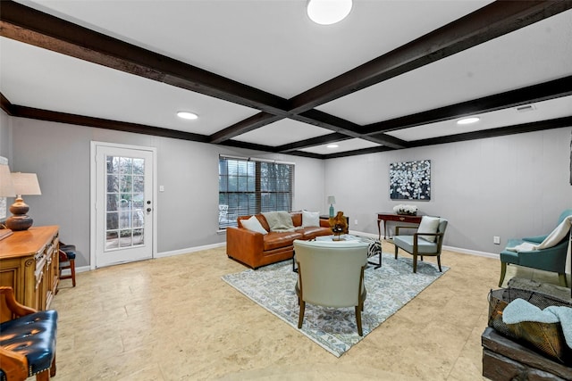 living area with visible vents, baseboards, and beam ceiling