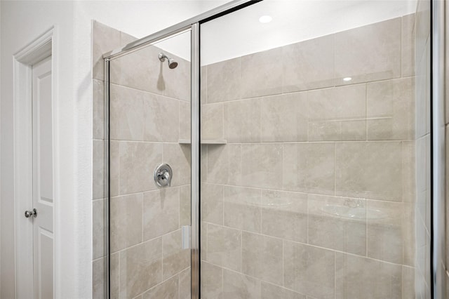 bathroom with a shower with door