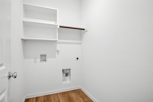 washroom featuring electric dryer hookup, hardwood / wood-style floors, washer hookup, and gas dryer hookup