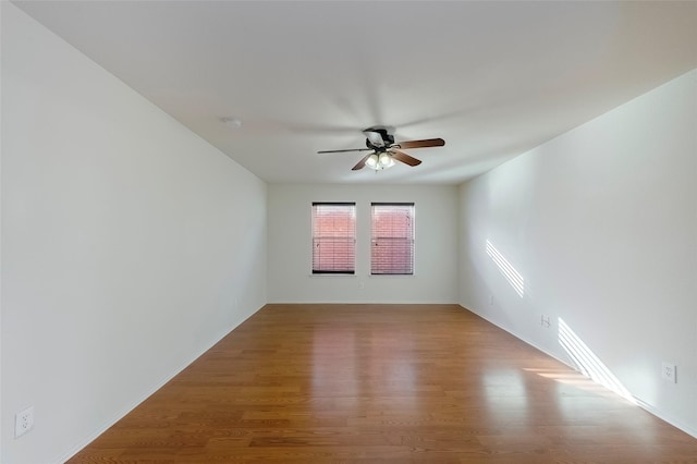 spare room with hardwood / wood-style flooring and ceiling fan