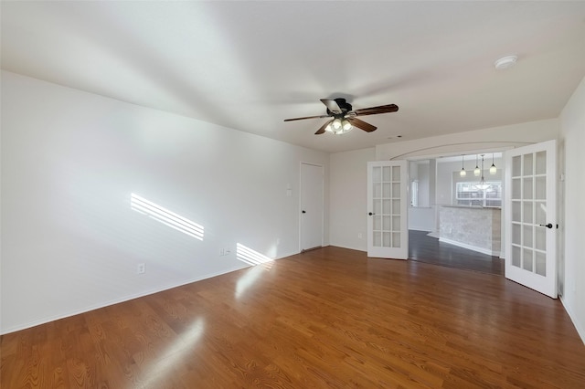 unfurnished room with dark wood-type flooring, ceiling fan, and french doors