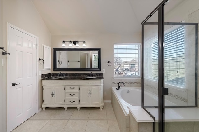 bathroom with independent shower and bath, vaulted ceiling, tile patterned flooring, and vanity