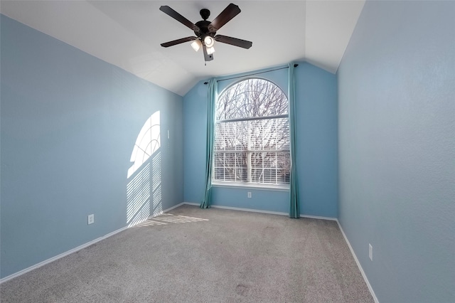 empty room with light carpet, vaulted ceiling, and ceiling fan