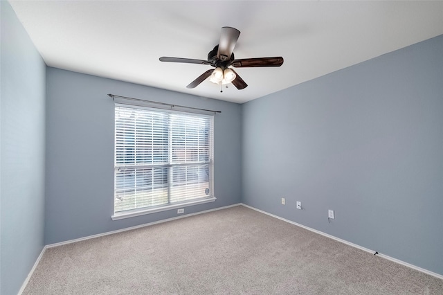 spare room featuring carpet floors and ceiling fan