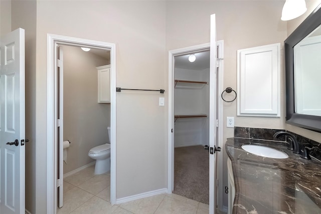 bathroom with vanity, tile patterned floors, and toilet