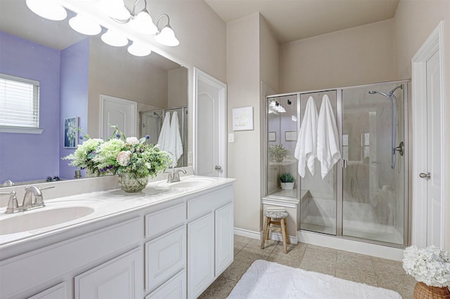 bathroom featuring a notable chandelier, vanity, and an enclosed shower