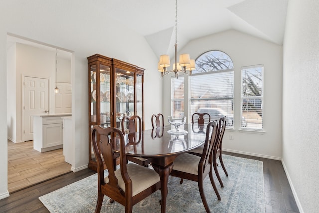 dining space featuring lofted ceiling, light hardwood / wood-style floors, and an inviting chandelier