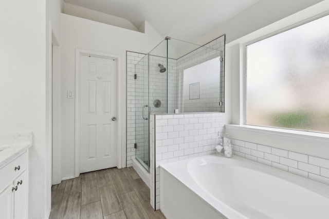 bathroom featuring vanity, wood-type flooring, and independent shower and bath