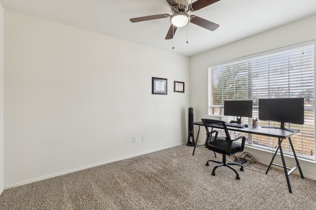 carpeted office space with ceiling fan