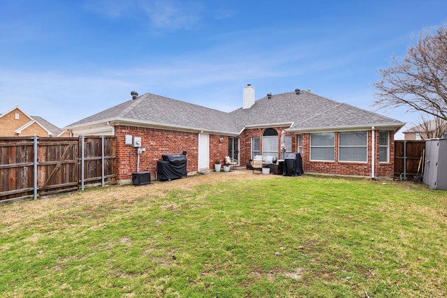 back of property featuring a patio area and a lawn