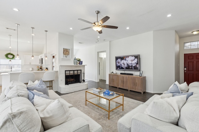 living room featuring hardwood / wood-style floors, a fireplace, and ceiling fan