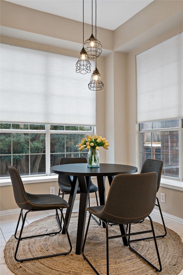 dining room with a healthy amount of sunlight and light tile patterned floors