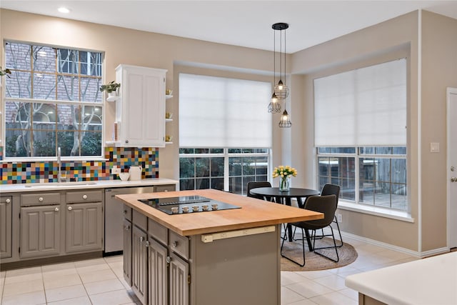 kitchen featuring sink, white cabinetry, hanging light fixtures, gray cabinets, and a kitchen island