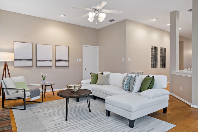 living room featuring light hardwood / wood-style floors and ceiling fan