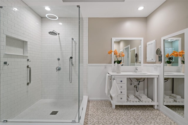 bathroom featuring walk in shower, sink, and tile patterned flooring