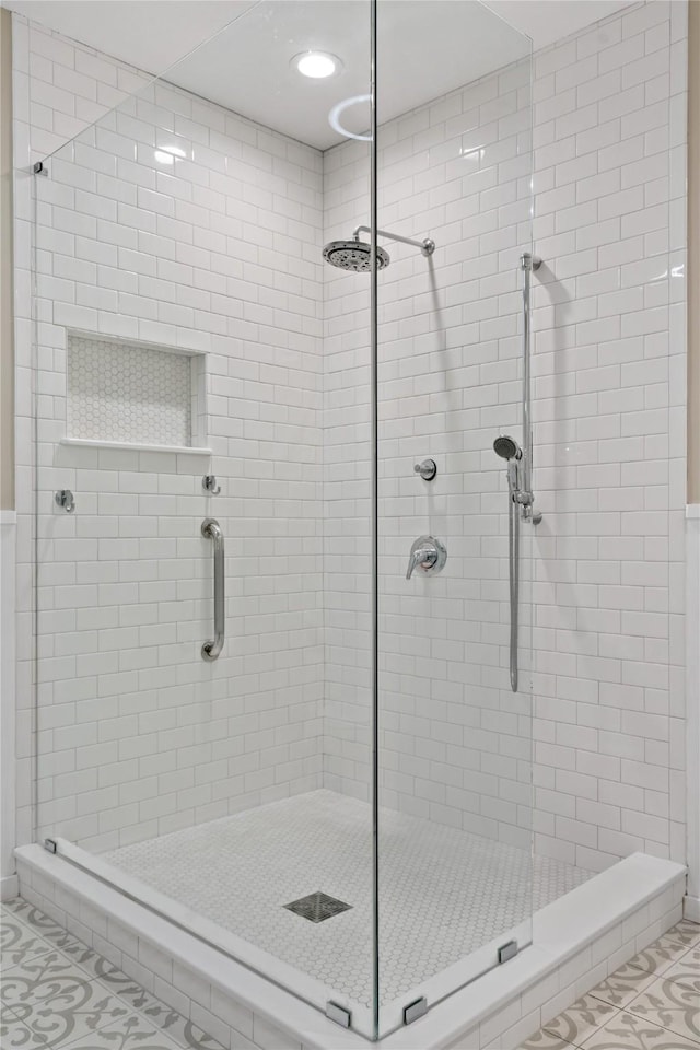 bathroom featuring tile patterned floors and a shower with shower door