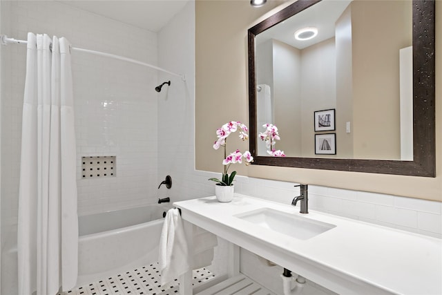 bathroom with sink and shower / bath combo with shower curtain