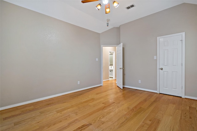 unfurnished bedroom featuring vaulted ceiling and light hardwood / wood-style floors