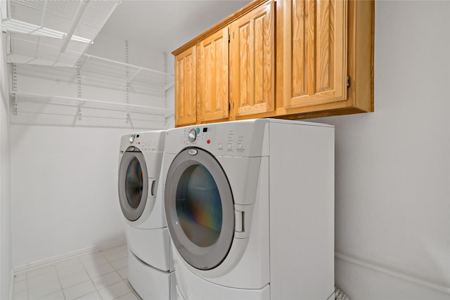 laundry area with cabinets and washer and clothes dryer