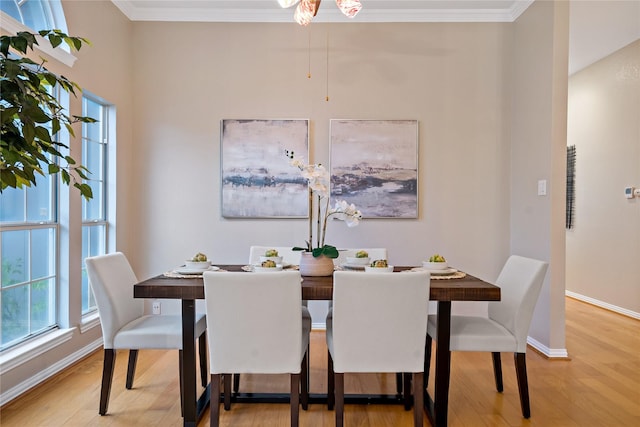 dining area with ornamental molding and hardwood / wood-style floors