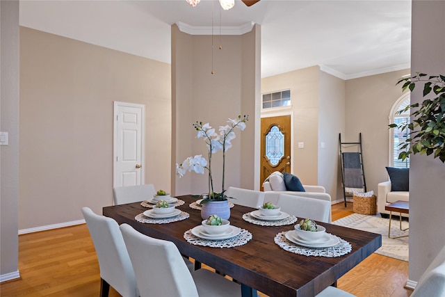 dining room featuring crown molding and light hardwood / wood-style floors