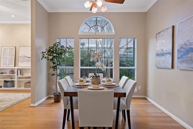 dining space with crown molding, ceiling fan, and light hardwood / wood-style floors