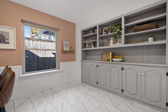 unfurnished dining area with built in shelves