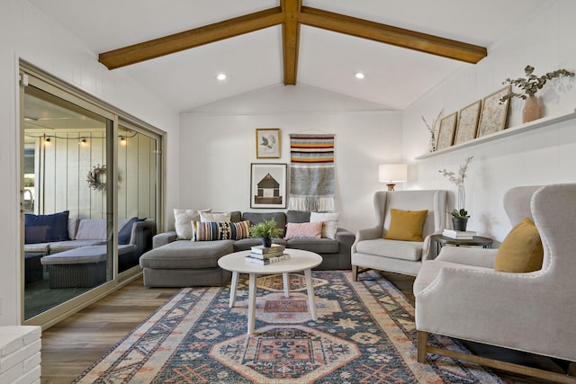 living room featuring wood-type flooring and vaulted ceiling with beams