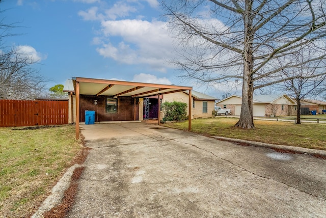 ranch-style house featuring a carport and a front yard