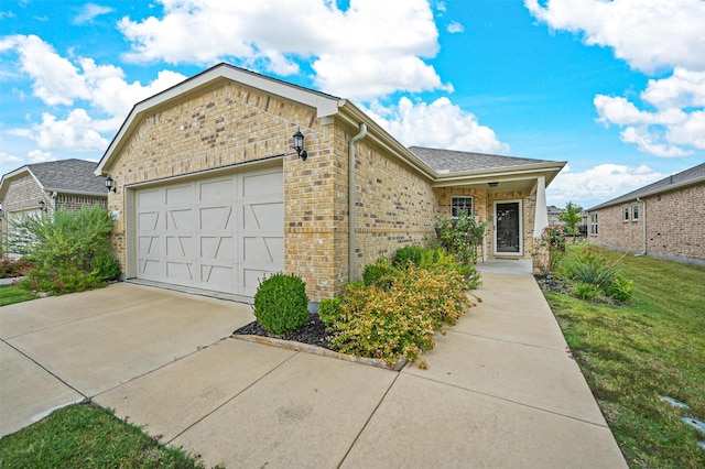 view of front of home featuring a garage and a front lawn