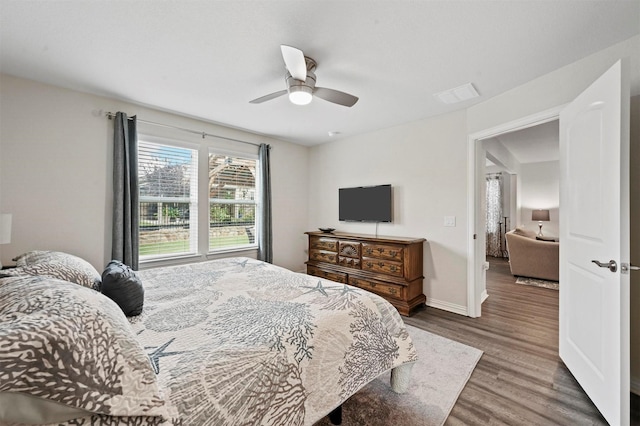 bedroom with hardwood / wood-style floors and ceiling fan