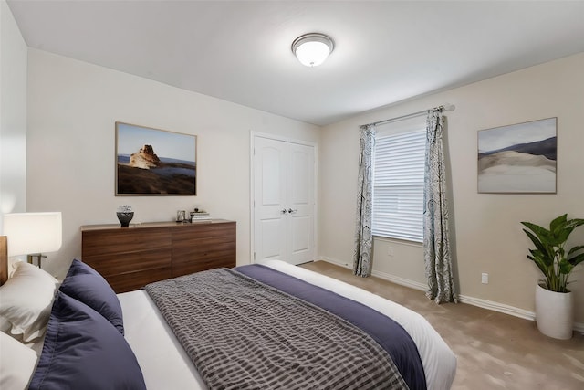 bedroom featuring light colored carpet and a closet