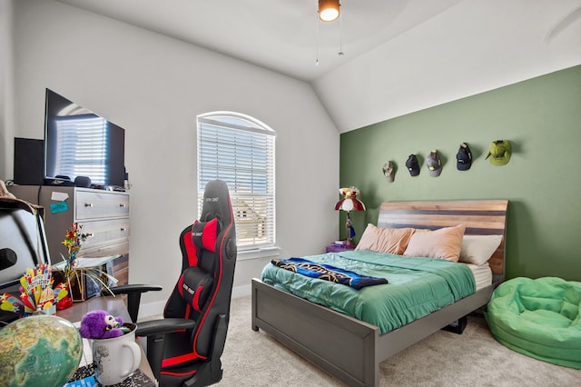 carpeted bedroom with lofted ceiling