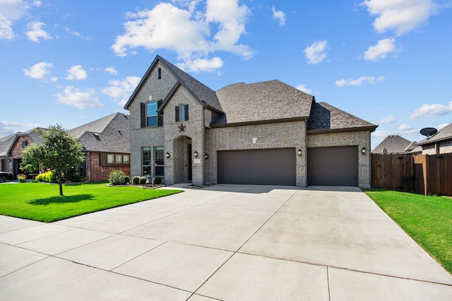 view of front of property with a garage and a front lawn